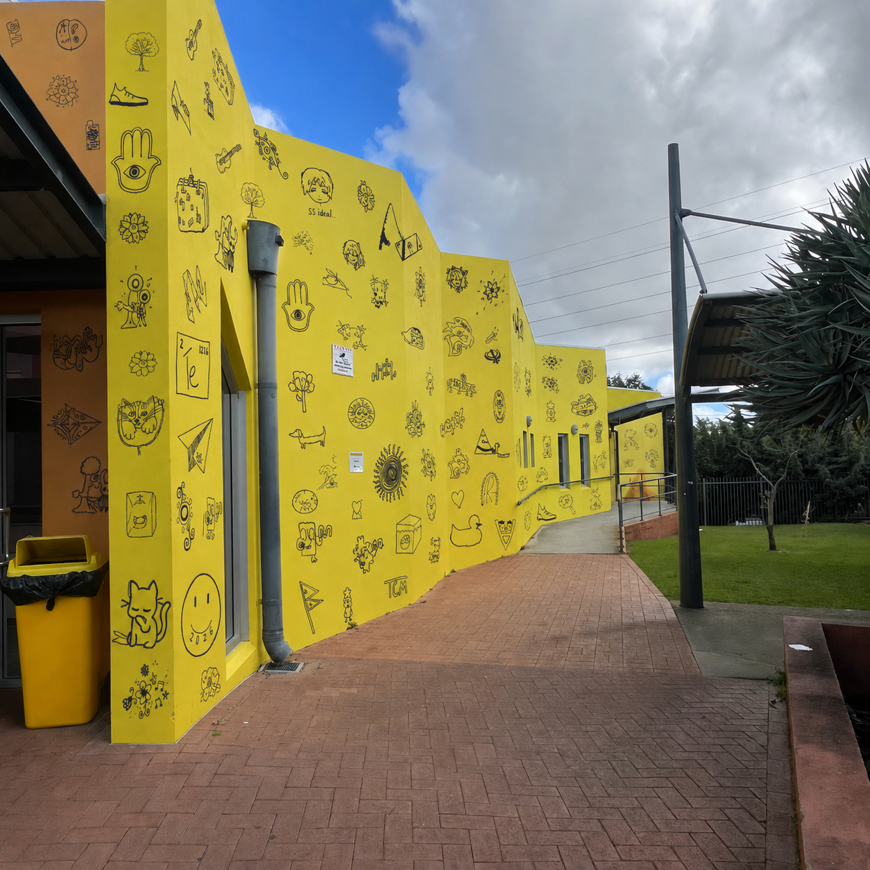 Student symbols applied across a yellow school wall
