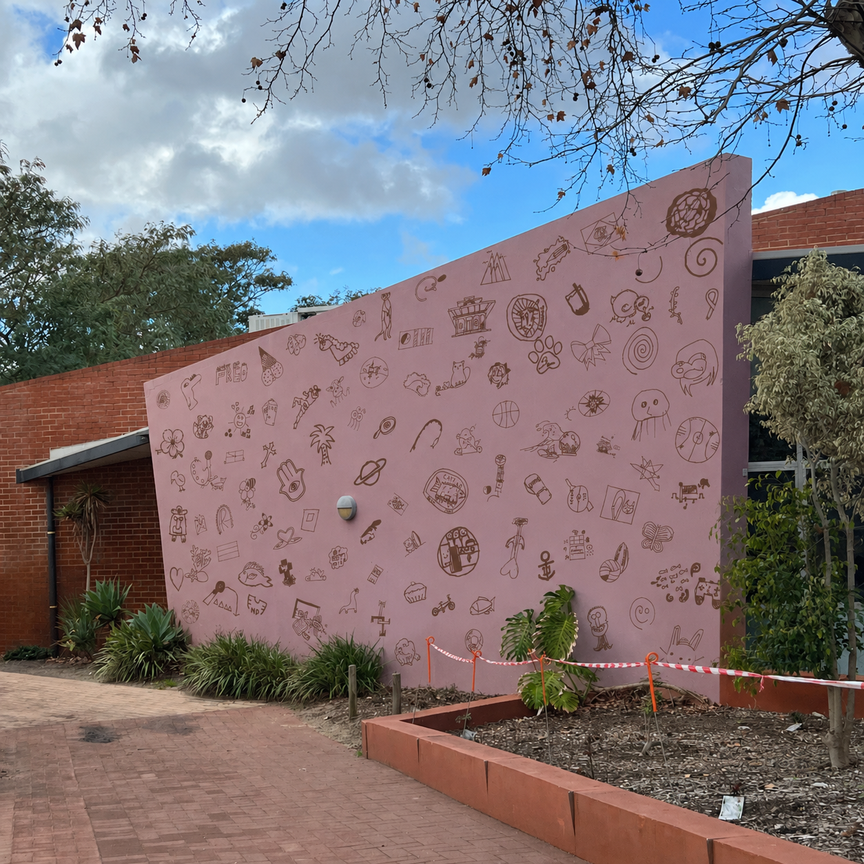 Student symbols applied across a pink school wall