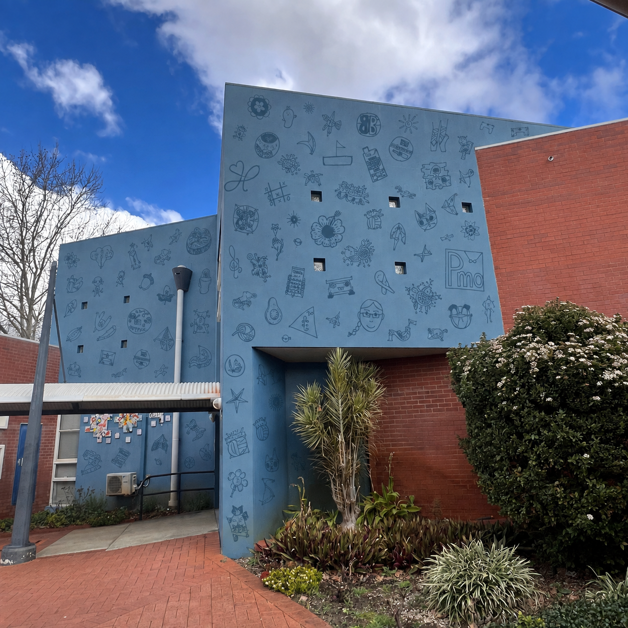 Student symbols applied across a blue courtyard building