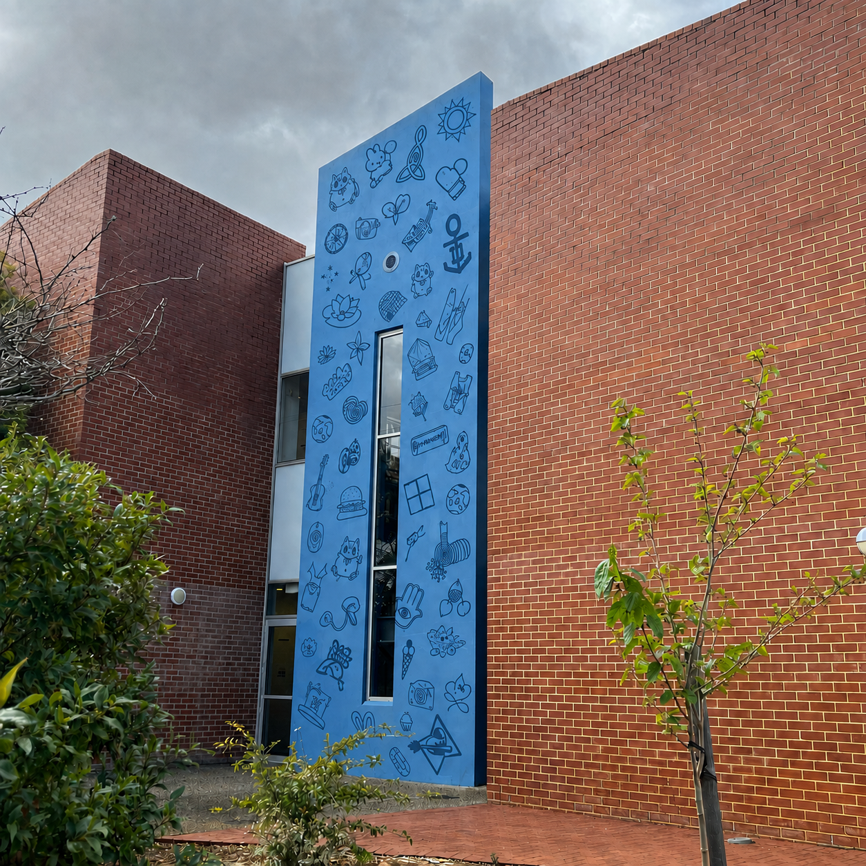 Student symbols applied vertically across a blue school wall